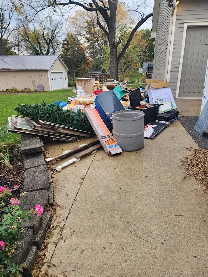 Dumpster being loaded with debris for Estate Cleanout Dumpster Rental in Castle Pines Village